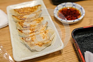 Selective focus, close up Japanese dumplings is called Gyoza or Jiaozi in China, gyoza with pork meat and vegetables on white