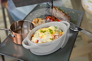 Selective focus and close up shot of well prepared beef juicy steak with luxury decoration of mash potato, sauce and tomatoes