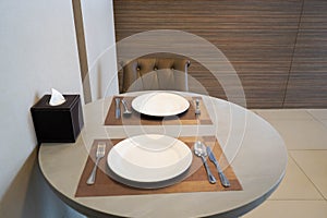 Selective focus close up white ceramic dish on dining table for couple dinner in dining room