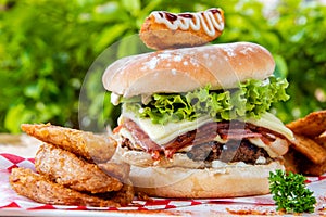 Selective focus closeup of a burger sandwich and potato fries