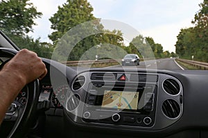 Selective focus closeup of a car dashboard while driving on the road