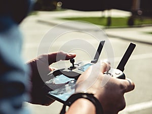 Selective focus closeup shot of a person holding black drone remote controller