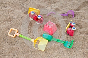 selective focus colorful children's toys on the sand Toy car and toy shovel concept in the technology age Children only play