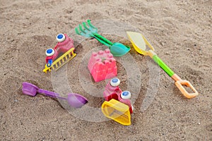 selective focus colorful children's toys on the sand Toy car and toy shovel concept in the technology age Children only play