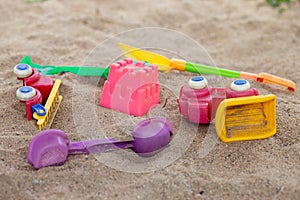 selective focus colorful children\'s toys on the sand Toy car and toy shovel concept in the technology age Children only play