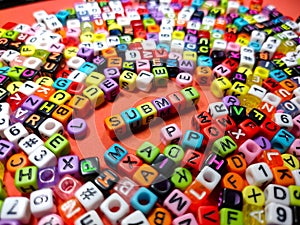 Selective focus.Colorful dice with word SUBMIT on red background.Shot were noise and film grain.