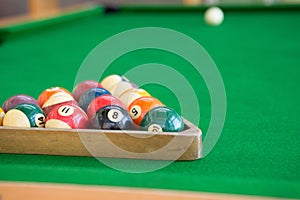 Selective focus of Colorful pool balls on green pool table