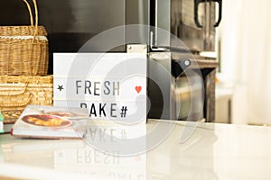 Selective focus with copy space of white and clean marble table top or counter of bright kitchen for bakery with baker oven and