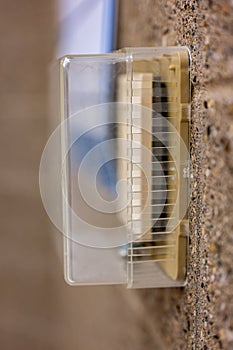 Selective focus on covered thermostat that is locked to prevent changing temperatures
