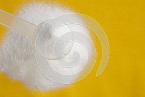 Selective focus of creatine monohydrate powder in measure spoon photo