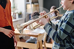 Kid Playing Brass Instrument During Music Class