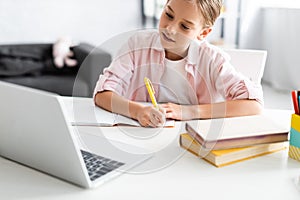 Selective focus of cute child writing