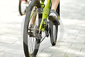 selective focus. cyclist on a bicycle leg and wheel close-up. Back view.