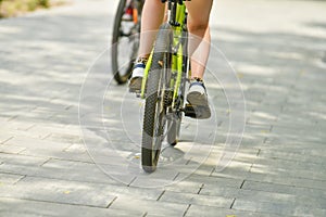 selective focus. cyclist on a bicycle leg and wheel close-up. Back view.