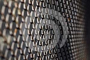 Selective focus of dark metal mesh fence
