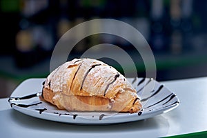 Selective focus of delicious croissant poured with chocolate photo