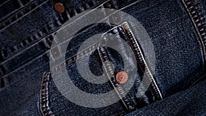 Selective focus on denim jean jacket pocket in clothes shop. Denim jacket pocket and button texture. Textile industry. Jeans