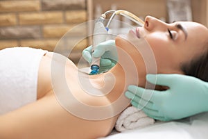 Selective focus of dermabrasion device in the hand of cosmetologist photo