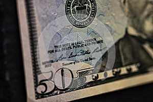 Selective focus on detail of 50 dollars banknote. Close up macro detail of money banknotes, dollars isolated. World money concept