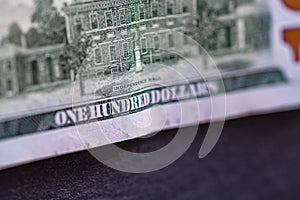 Selective focus on detail of 100 dollars banknote. Close up macro detail of money banknotes, dollars isolated. World money concept