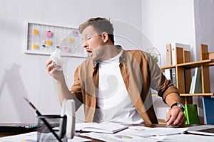 Focus of diseased businessman holding napkin