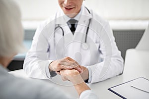 Selective focus of the doctor holding hand of patient