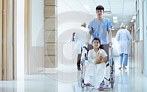 Selective focus on doctor and a patient at hallway of hospital