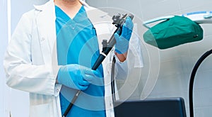 Selective focus on doctor's hands holding an endoscope.