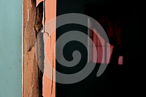 Selective focus of door wooden beam frame damaged by termites with black copy space. Abandoned deteriorating house concept.