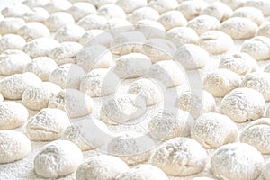 Selective focus of dough balls on white wooden board