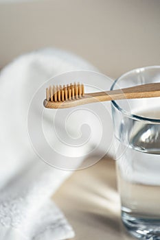 Selective focus on eco friendly wooden brush with soft fiber for sensitive teeth photo