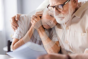 Selective focus of elderly man embracing