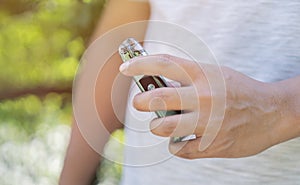 Selective focus of an electronic cigarette in man's hand, smoking and vaping negative health effects