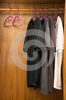 Selective focus empty coat hanger in wardrobe