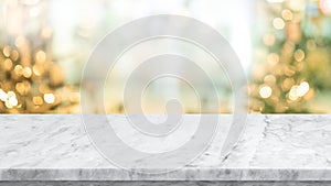 Selective focus.Empty marble table top with blur christmas tree,ornament background