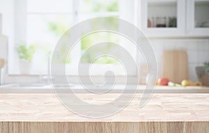 Selective focus.End grain wood table counter top on blur kitchen in morning window background