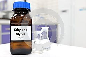 Selective focus of ethylene glycol liquid chemical compound in dark glass bottle inside a chemistry laboratory with copy space.