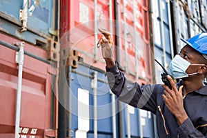 Selective focus at face of Black African man worker wearing surgical face mask and  safety equipment while check and inspection