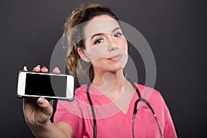 Selective focus of female doctor holding black screen smartphone photo