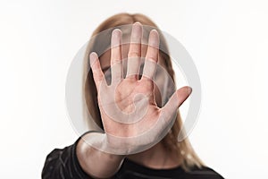 Selective focus of female victim of bullying showing stop sign isolated on white.