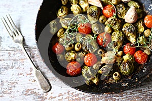 Brussels sprouts with vegetables and herbs in a pan. Cooking Brussels sprouts. Vegan food. Selective focus.