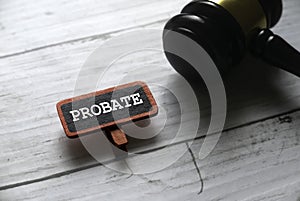 Selective focus of gavel and red tag written with PROBATE on white wooden background