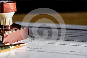Selective focus on generic professional engineer, architecture. or surveyor stamp and certification statement photo