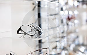 Selective focus at glasses frame on the shelf inside of the store for customer choice and selection. With different color and