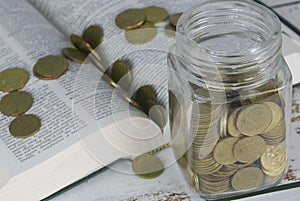 Selective focus of Gold coins on book. Finance and education concept