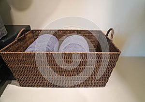 Selective focus grey cotton towel in basket for taking shower