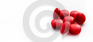 Selective focus, group of red medical pills isolated on white background.Health and medicine concept