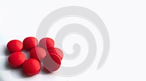 Selective focus, group of red medical pills isolated on white background.Health and medicine concept