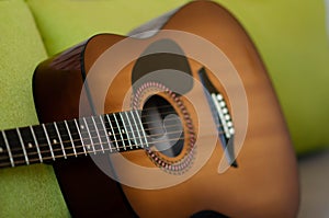 Selective focus guitar fretboard with strings on blurred gray background with copy space. Music concept. Guitar neck texture. Gray