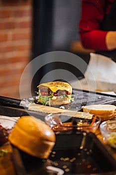 Process of cooking of tasty burger in burger bar